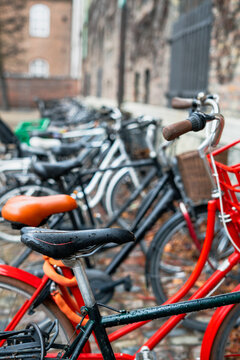 Close up of bicycle seat with colorful bicycles on background