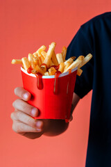 Hands of person holding french fries