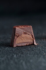 Delicious gourmet homemade dark chocolate candy from confectionery on black background