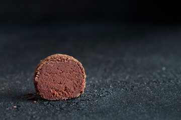Delicious gourmet homemade dark chocolate candy from confectionery on black background