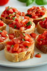 Homemade Bruschetta with Basil and Tomatoes on a Plate, side view.