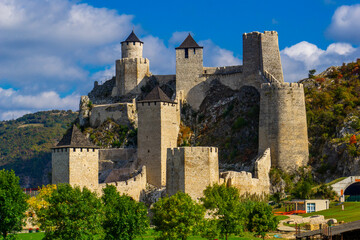 Fototapeta premium Majestic view of Golubac fortress overlooking Danube river in Serbia on a sunny afternoon