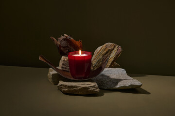 Burning handmade candle in a glass jar with empty label mockup