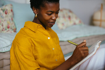Woman taking notes on workplace