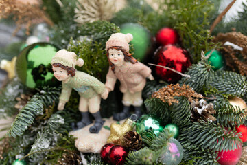 Couple Figurines Sitting on Top of a Christmas Tree