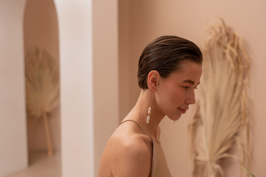 Portrait of young woman with pearl earrings