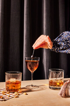 Hand with whiskey drinks