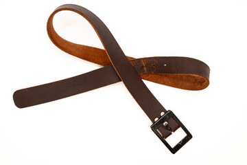 Worn Men's leather belt in a dark brown color with a metal buckle on white background. Top view or flat lay.