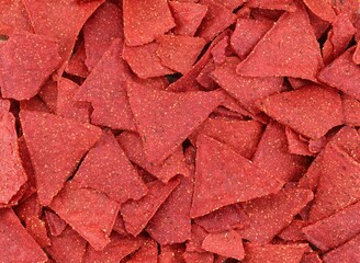 Red nachos or red tortilla, flavored  with beet and chili. Top view , texture and full frame.