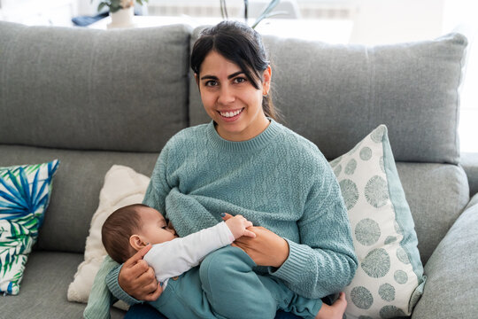 Young mother smiling with baby at home