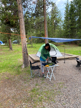 Woman cooking in a camping site on the forest