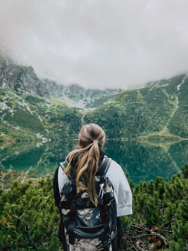 UGC Young woman near emerald mountain lake