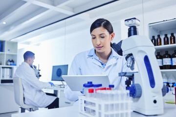 Woman, technician and medical research for covid 19, vaccine and tablet with lab equipment for pharma innovation. Female person, scientist and tech in healthcare for chemistry in forensic for results