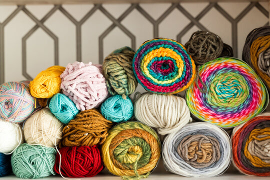 Colorful assortment of yarn balls on shelves