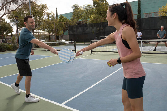 friends outside during a game of pickleball