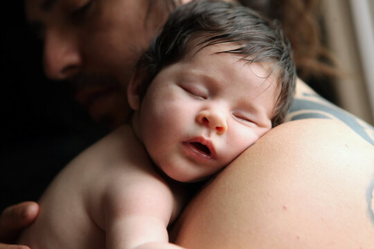 Close Up Of Baby Sleeping on Parents Shoulder