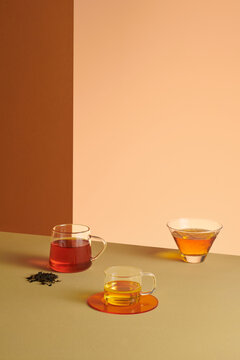 Three cups of tea on beige table