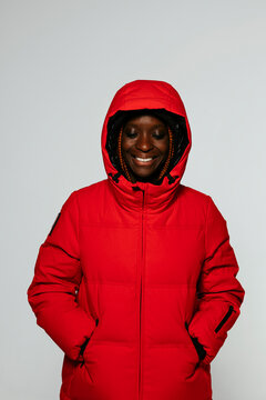 Smiling woman in red winter outfit in studio