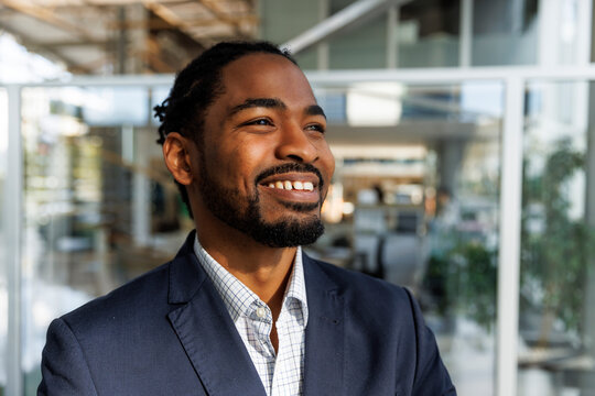 Close-up shot of confident businessman in blazer at office