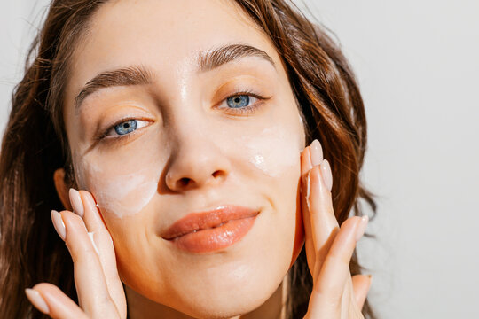 A Woman Applying Facial Cream Skincare Routine
