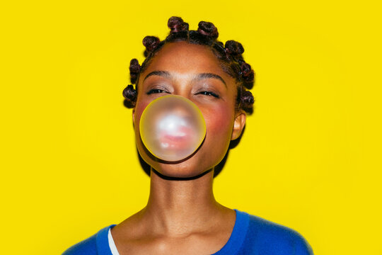 Woman blowing bubblegum balloon