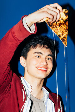 Young man with pizza slice
