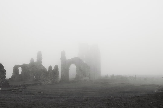 Foggy ruins of an ancient stone building in Tynemouth Priory and Castle