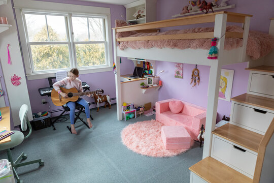 Child Bedroom in home with bunk bed in Home playing guitar 