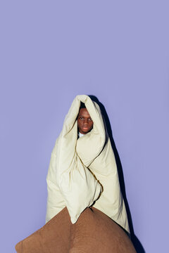 Man with quilt and pillows