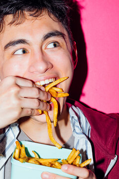 Guy eating french fries