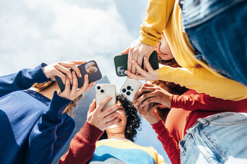Young girls enjoying time together with cellphones