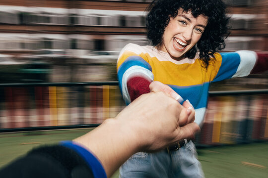 Joyful girl in a colorful sweater smiling at camera