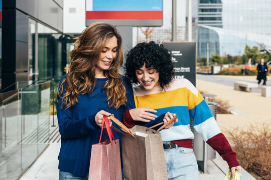 Young girls sharing shopping experience in Madrid