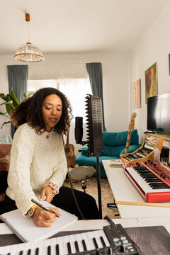 Young woman composing song lyrics