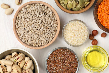 Different products high in vegetable fats on white wooden table, flat lay