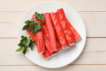 Tasty crab sticks and parsley on wooden table, top view © New Africa