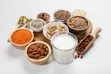 Different products high in natural fats on white wooden table