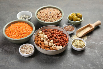 Different products high in natural fats on grey table