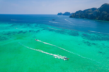 longtail boat turquoise clear water in Phi Phi, Krabi Thailand. Amazing travel landscape photo in...