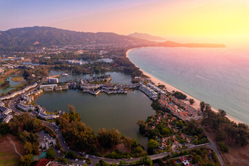 Aerial top view panorama sunset Bang Tao beach with lux hotel of Phuket paradise. Concept tropical...