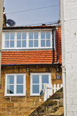 Charming two-story house with red-tiled roof and white-framed windows Robin Hood's Bay, Yorkshire