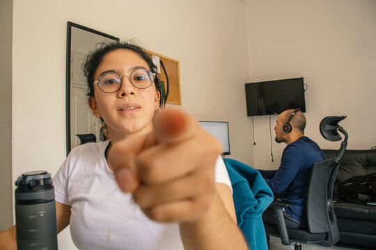 Woman Pointing at Camera While Working from Home Office