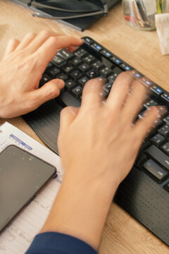 Hands Typing fast on Keyboard Working Remotely at Home
