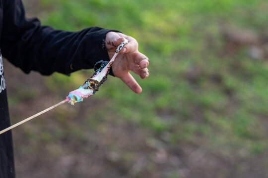 Child With Roasted Marshmallows On Stick.