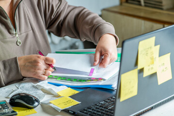 Anonymous hands of an accountant working with documents