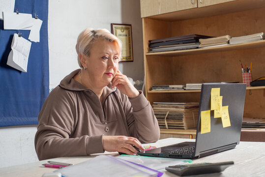 Accountant working at a laptop in the office among documents