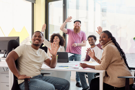 Friendly Office Team Waving Hello