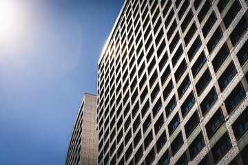 A modern multi-storey residential building against the background of a blue sky. Apartments in a big city, real estate