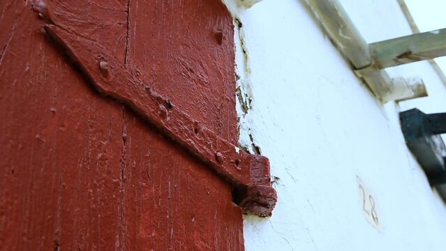 Detail of the old hinge and door of a fishermen's hut in Cala S'Alguer. Palamos, Costa Brava, Catalunya, Spain.