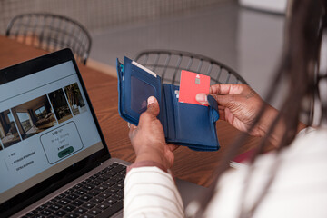 Anonymous woman taking credit card from wallet 